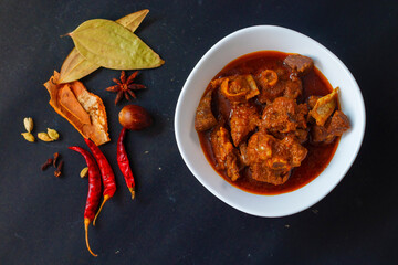 selective focus of delicious Indian style mutton curry with a decorative background.  - obrazy, fototapety, plakaty