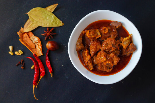 selective focus of delicious Indian style mutton curry with a decorative background. 