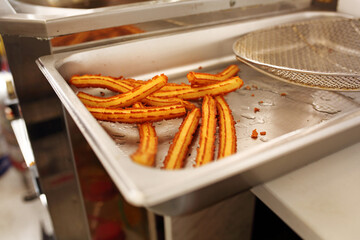 Churros production. Food truck serving traditional fried dessert from Spain, Portugal. Thin and...