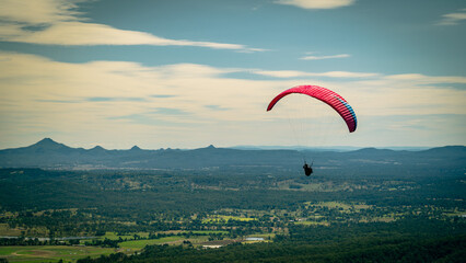 Paraglider flying above the Gold Coast landscape, Queensland, Australia