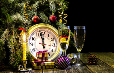 Holiday candles, gifts and champagne on a dark background - symbols of the celebration of the new year or christmas