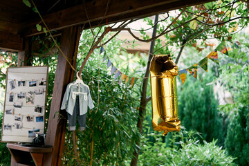 Flags and an inflatable digit 1 hang in the gazebo. High quality photo