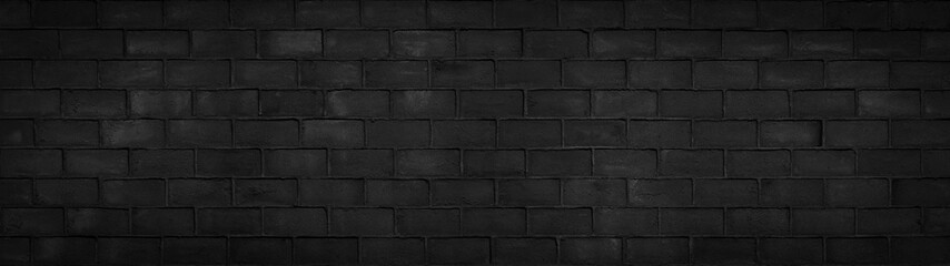 Black anthracite gray dark damaged rustic brick wall brickwork stonework masonry texture background banner panorama pattern..