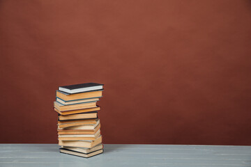 a stack of old instructional books on a brown background