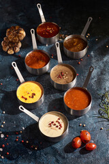 7 types of sauces served with beefsteak, served on a wooden table, top view
