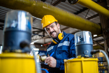 Gas pipe inspector doing quality control inside refinery storage room.