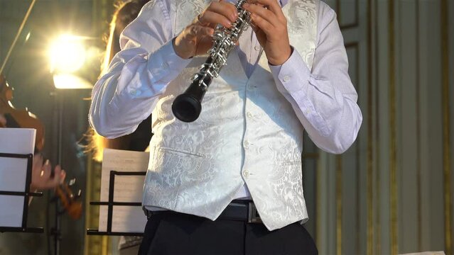 Musican is playing the modern Oboe.