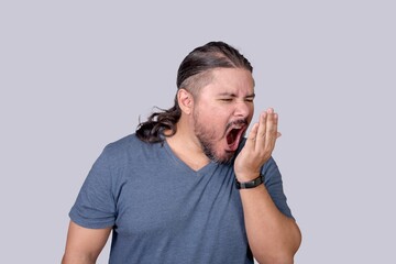 A man checks for bad breath by breathing into his palm. Checking for signs of Halitosis or other oral problems.