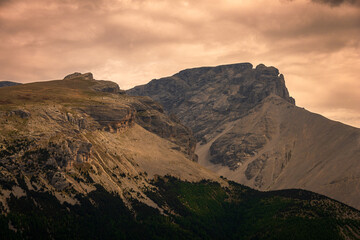 small peaks in the The French alps with stormy weather clouds , changing climate .