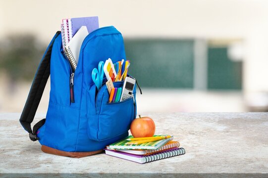 School classroom. New school bag on a student's desk in the classroom. Back to school concept