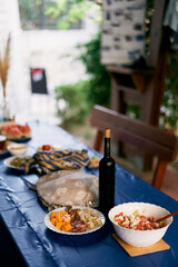 Festive set table with appetizers and a bottle of wine. High quality photo