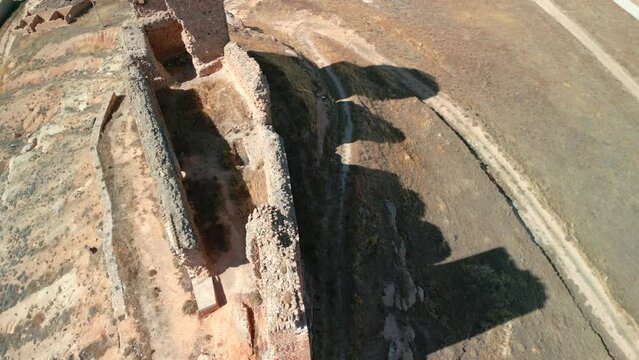 Aerial zenithal image of an old ruined castle in Spain Europe medieval time without people dry arid open laSpectacular aerial image taken with a drone of a ruined castle in Spain ancient medieval town