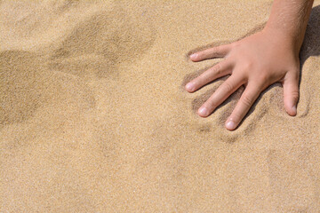 Child leaving handprint on sand outdoors, closeup with space for text. Fleeting time concept