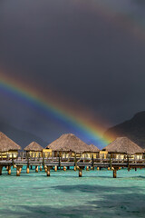 Multicolored rainbow arch Bora Bora luxury Overwater bungalows
