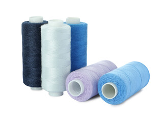 Many different colorful sewing threads on white background