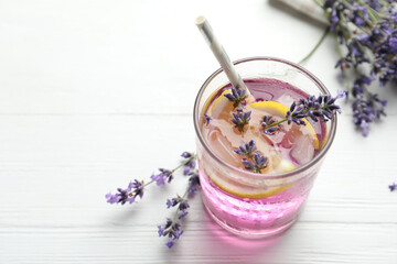 Fresh delicious lemonade with lavender on white wooden table. Space for text