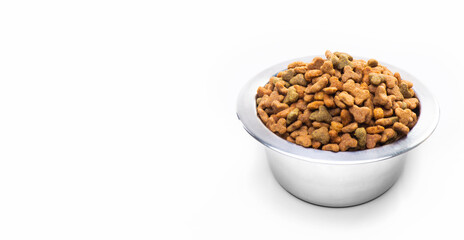 Metal bowl with dry food for cats and dogs isolated on white background