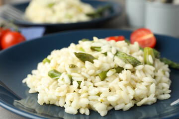 Delicious risotto with asparagus in plate, closeup