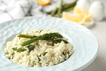 Delicious risotto with asparagus in plate, closeup