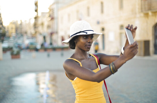 young woman in the street takes a selfie
