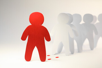 White paper human figures following red one on light background. Responsibility concept