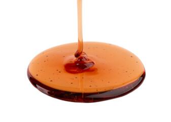 Caramel syrup drizzle isolated on white background. Splashes of sweet caramel sauce.