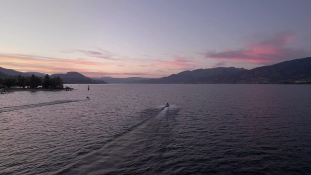 Aerial drone footage jet skis on lake at sunset, sea doo, water sport, fun adventure, water craft, Okanagan sunset. 4K PRORES 24FPS.
