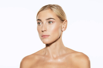Portrait of young female fashion model with nude makeup isolated on white studio background. Spa, surgery, face lifting and skin care concept