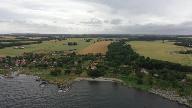View over small village at the coastline of the danish island Bornholm. Drone footage in Denmark in summer