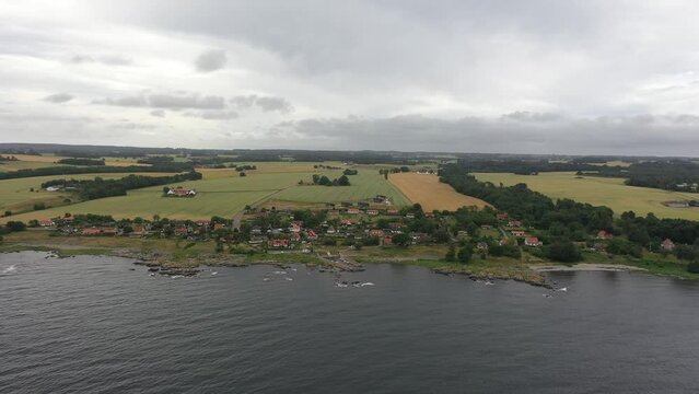 Drone view of small village at the danish island Bornholm in the summer. Far away view with fields in the background