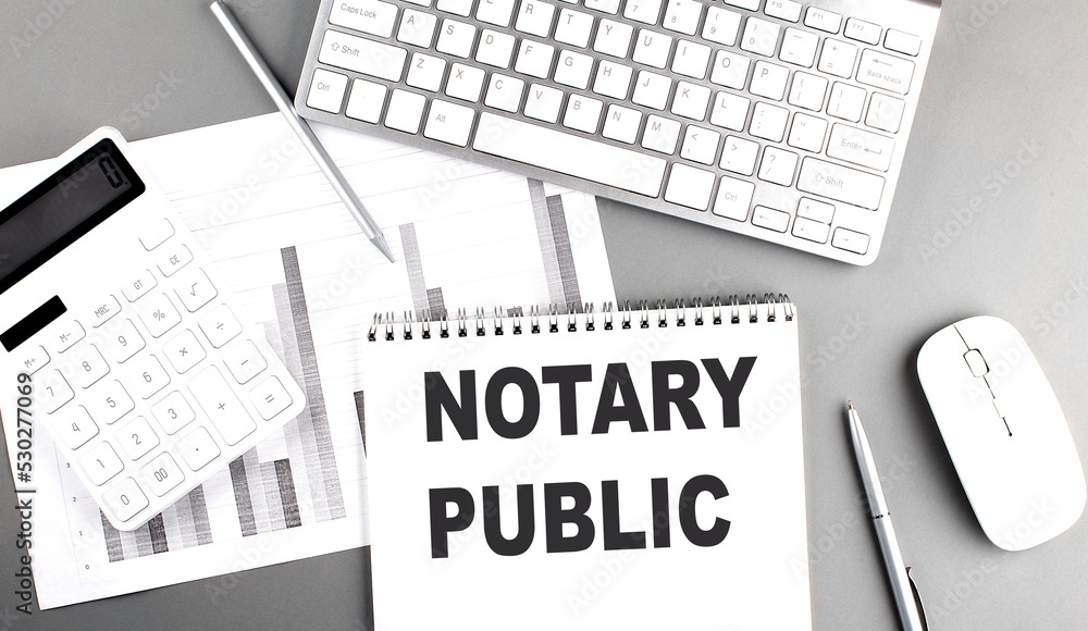 Aufkleber notary public text written on notebook on grey background with chart and keyboard , business concept