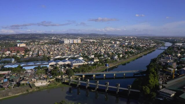 Wide view of the city showing the city bridge and the community around. Also the clean riverbank.