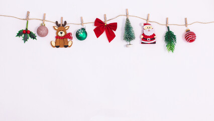 Various Christmas decorations and ornaments hanged on rope on white background with copy space. Flat lay New year holidays garland