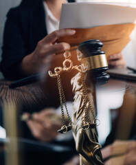 Business and lawyers discussing contract papers with brass scale on desk in office. Law, legal...