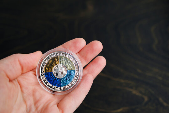 The first World 4 Colour Titanium Bi-Metal coin. Reverse side with Greek gods: Demeter brown, Zeus light blue, Poseidon dark blue, Hephaestus purple. 12 Zodiac Signs. Minsk, Belarus - 6 Sept 2022