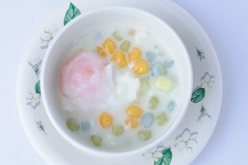 rainbow glutinous rice balls with sweet eeg on white background.Thai traditional dessert