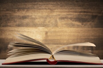 A retro old book on a wooden table.