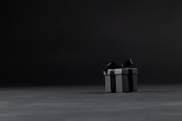Composition of present with black ribbon on gray background