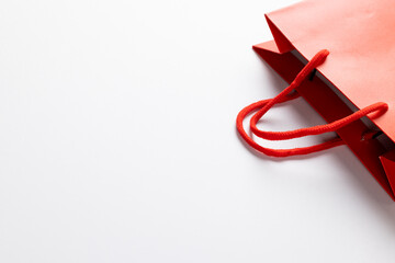 Composition of red paper shopping bag on white background