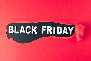 Composition of pink paper and black friday text on black background