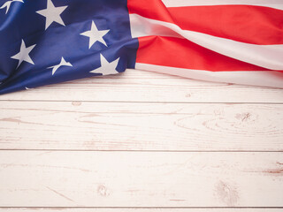 Top view of the American flag on a wooden table with copy space for text