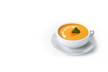 Carrot soup with cream and parsley isolated on white background. Copy space