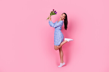 Full body profile photo of cute brunette millennial lady hold bouquet wear blue dress boots...