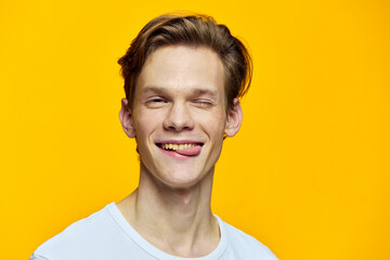 portrait of a cute, winking guy in a white t-shirt