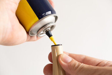 hands filling a lighter with a gas spray. picture closeup
