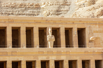 Fototapeta premium View of Hatshepsut's temple. Mortuary temple of the pharaoh of the Hatshepsut dynasty. Jeser-Jeseru is a masterpiece of ancient Egyptian architecture. The sanctuary is carved right into the rocks.