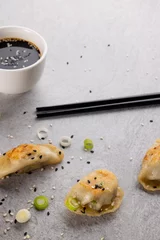 Foto op Aluminium Close up of asian dumplings, soy sauce and chopsticks on grey background © vectorfusionart
