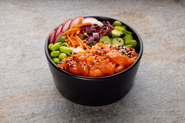 Overhead view of hawaiian poke bowl on grey background