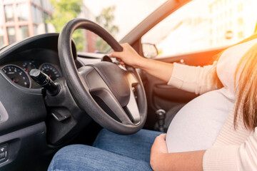 Pregnant woman driver. Beautiful smiling pregnancy woman driving car. Safety pregnant young mother drive concept. - obrazy, fototapety, plakaty