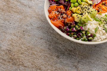 Overhead view of hawaiian poke bowl with copy space on grey background